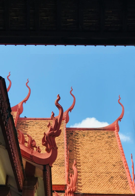 some red decorations are on the roof of a building