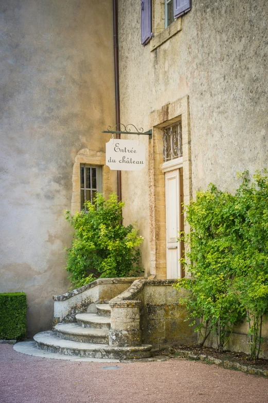 a stone building with steps that lead up to an entrance with a sign reading'the country inn at little lake