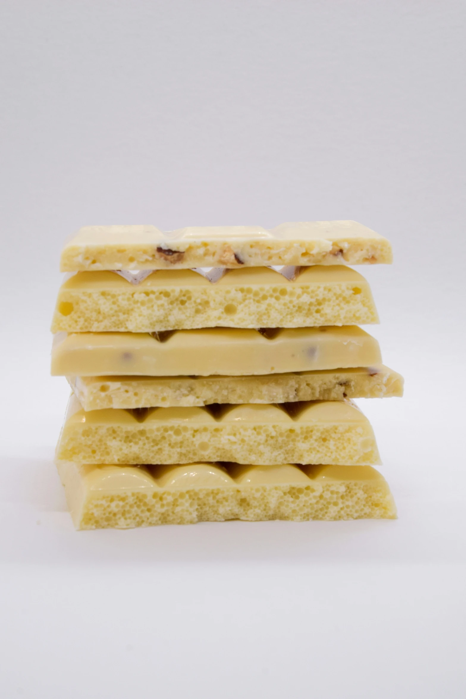 a stack of biscuits filled with icing on white background