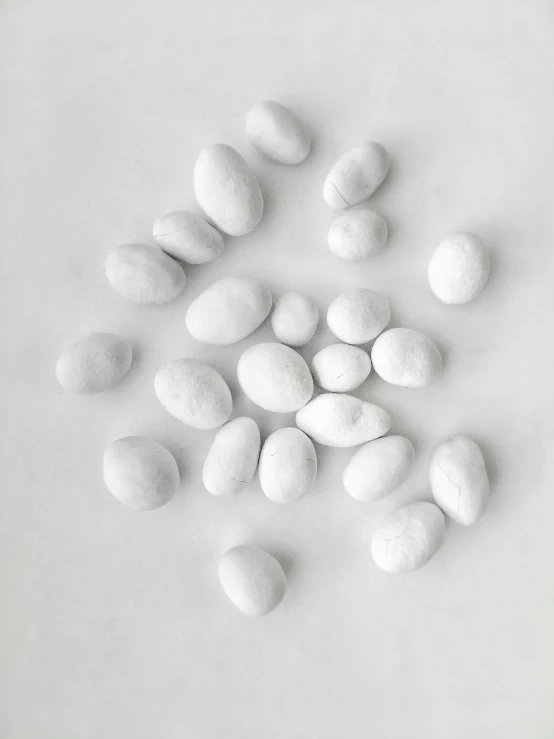 a white table topped with lots of white rocks