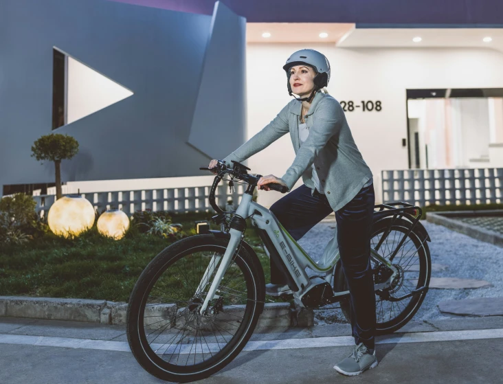 a woman riding a bicycle on a city street