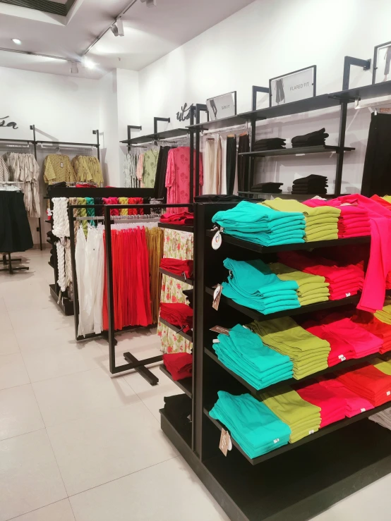 a clothing store filled with brightly colored shirts