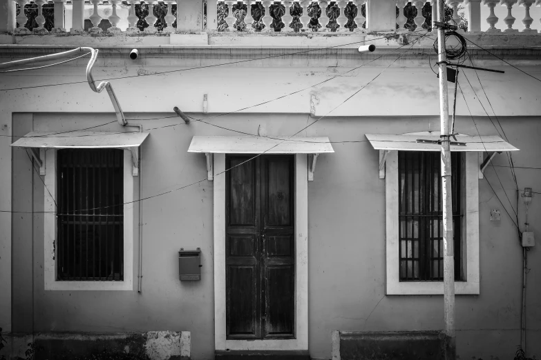 an old style door and windows sit beside a doorway on a home