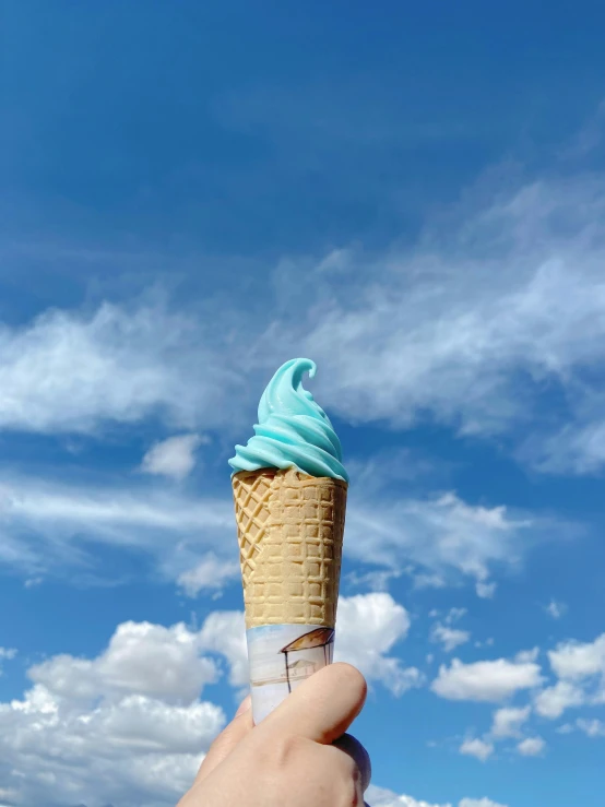 an ice cream cone being held in front of the camera