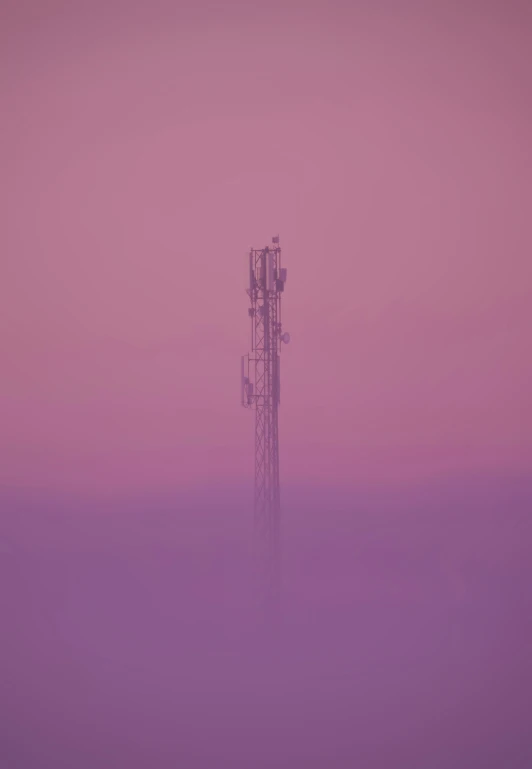 an electronic tower on a pink, cloudy day