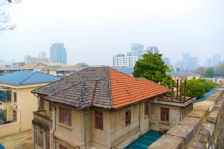 a small building on top of a bridge next to buildings