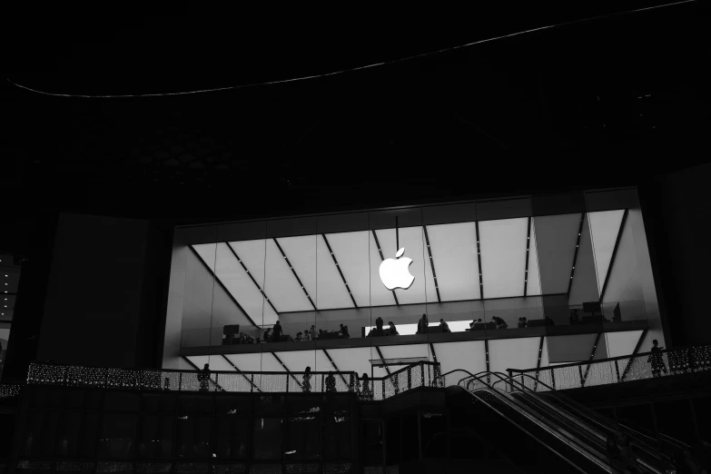 an apple store is lit up at night