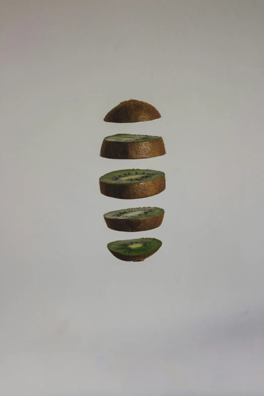 four small pieces of fruit are floating in the air