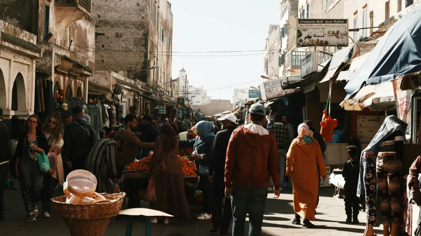 several people are walking through the street in a town