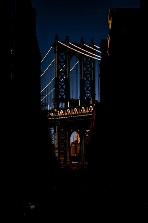 people walk over a bridge as the sun sets