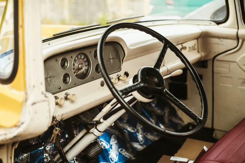 the dashboard and steering wheel inside of a yellow truck