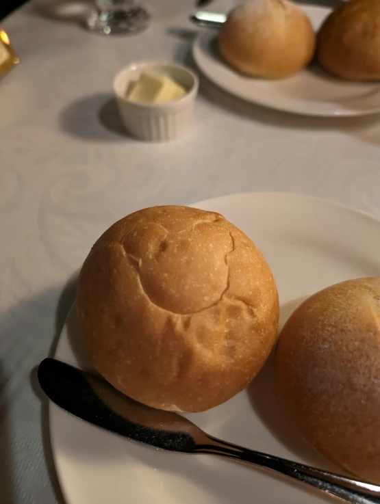 an empty plate with rolls sitting on it