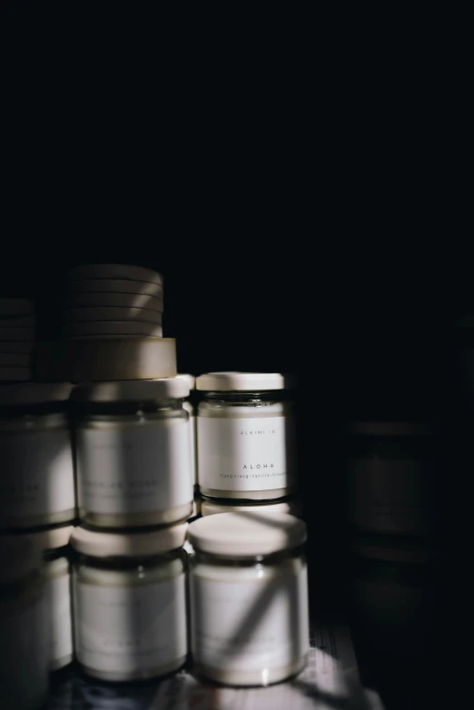 a pile of glass jars are stacked next to each other