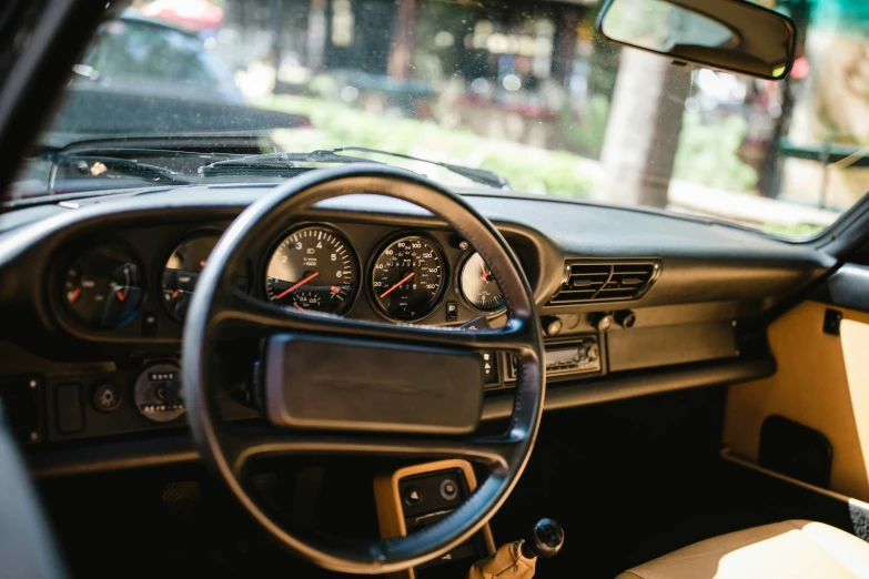 the dashboard of an old car with several gauges on