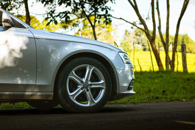 a car parked on the side of a road near trees