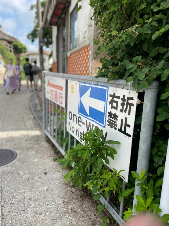 a sign pointing in to two ways on a sidewalk