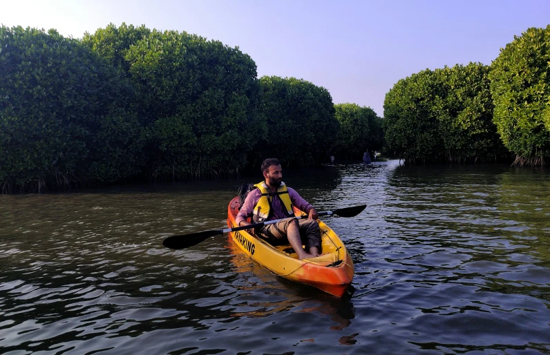 a man and a little girl in a yellow kayak