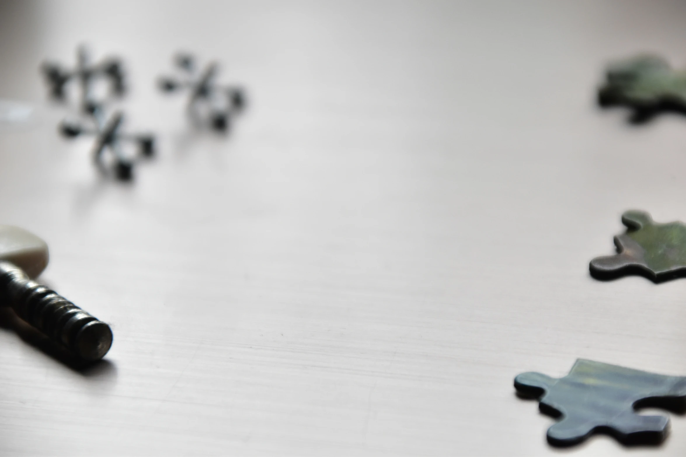 multiple jigsaw pieces spread out on a table