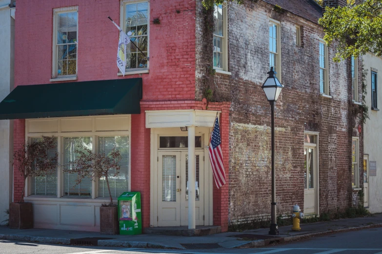 a street corner with shops and brick buildings