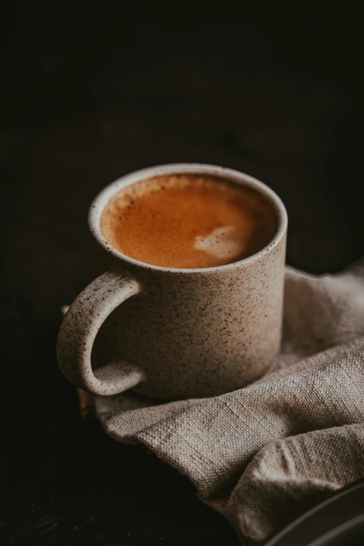 a white cup sits on a napkin