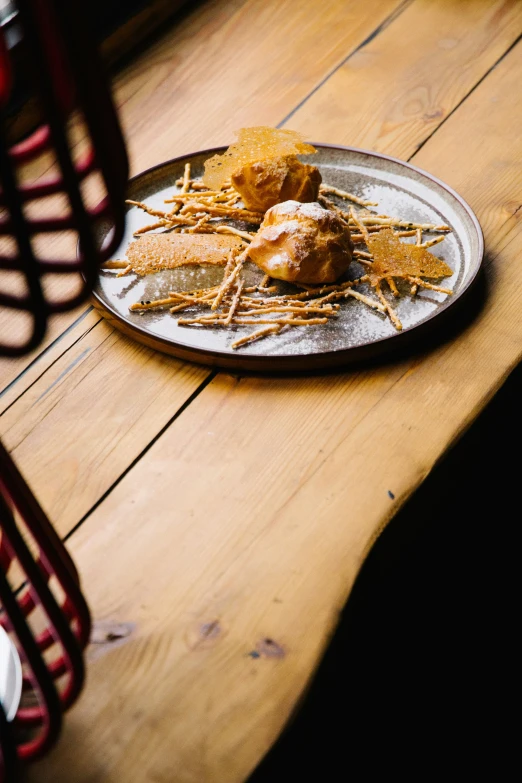 a plate full of chicken sitting on a wooden table