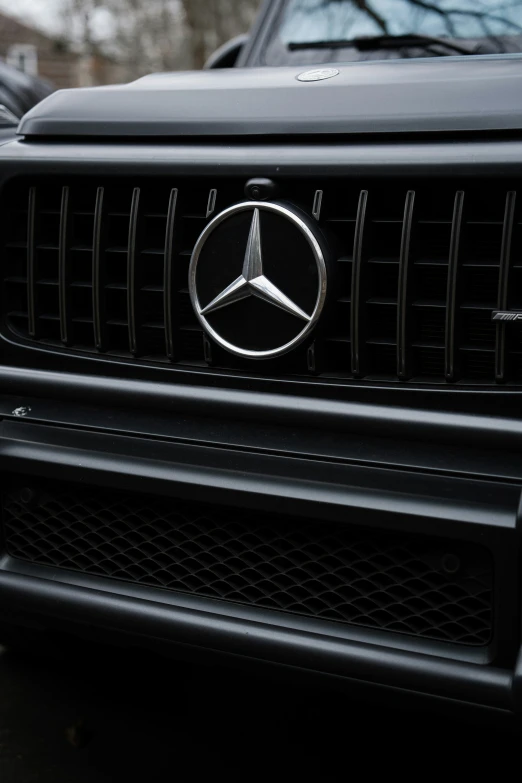 a mercedes benz logo is displayed on the grille