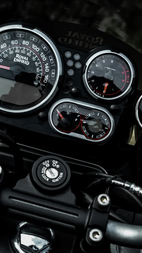 a motorcycle has gauges and dials on the handle bars