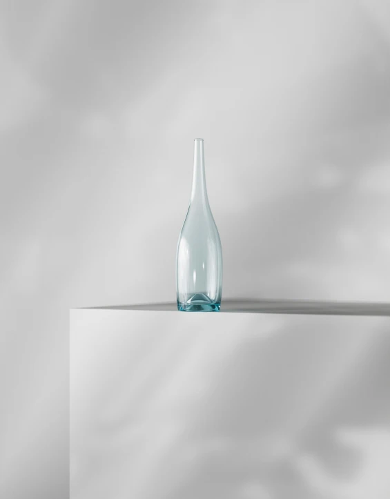 a clear bottle sitting on top of a white pedestal