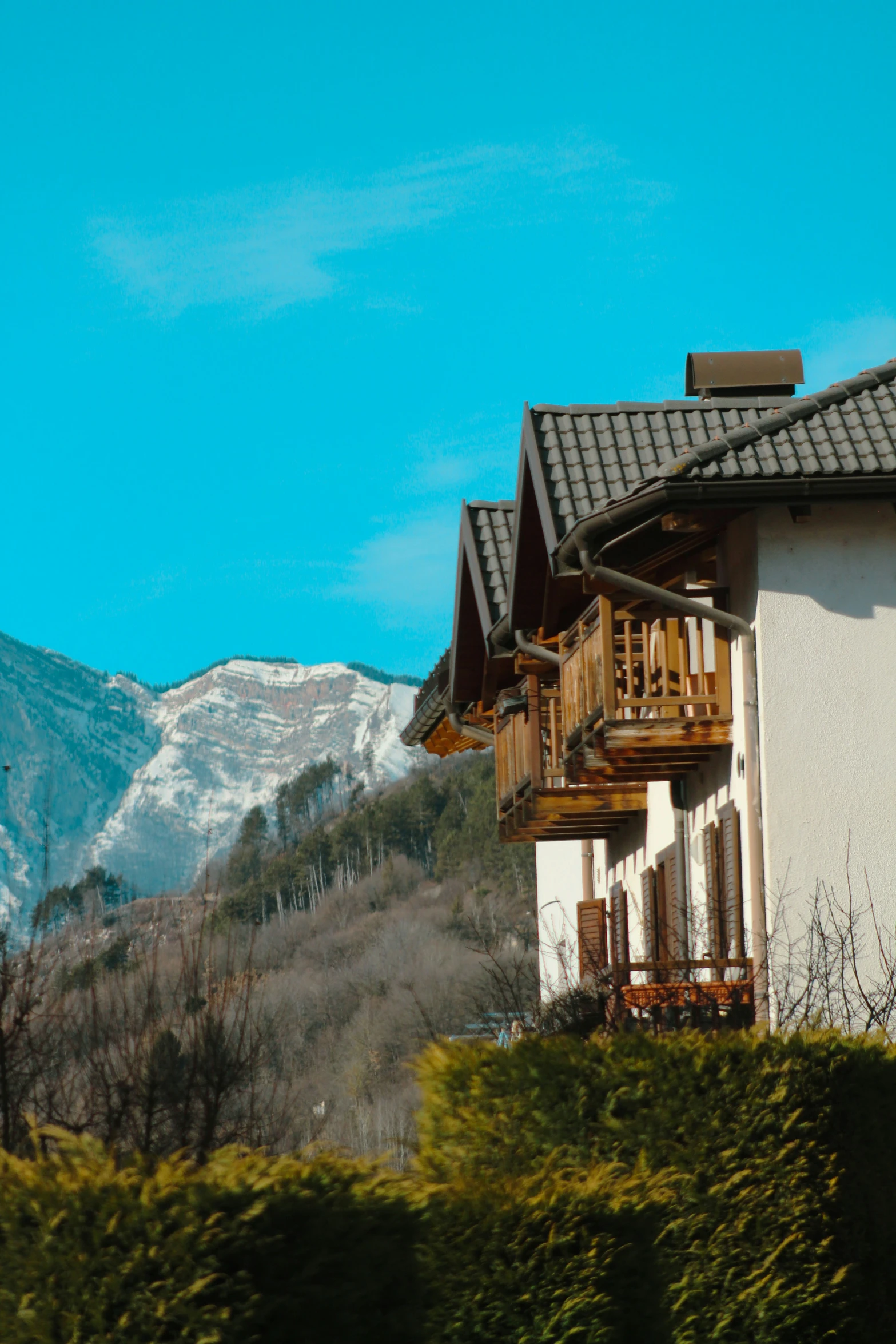 a white building in front of a mountain