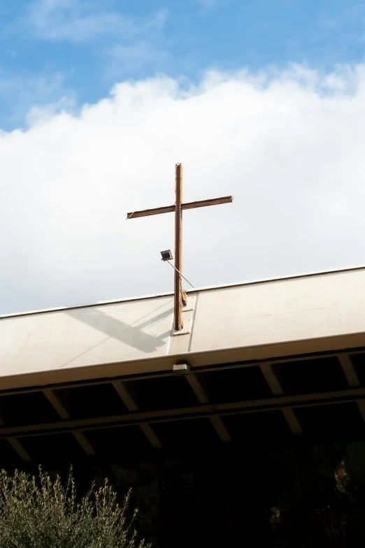 a large cross on top of a roof