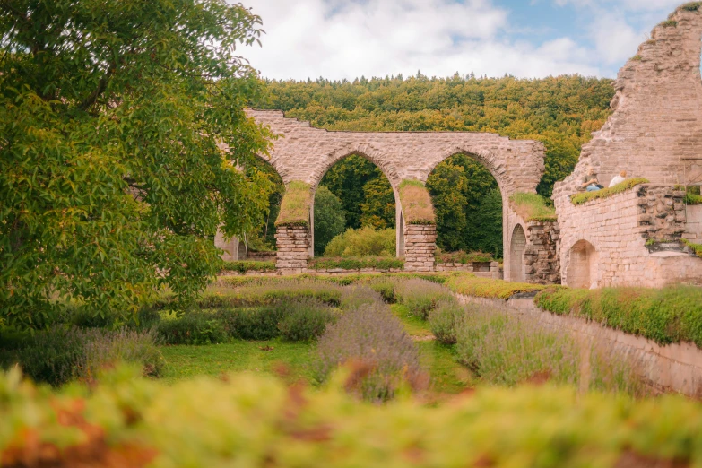 a stone archway and wall built into the side of a hill