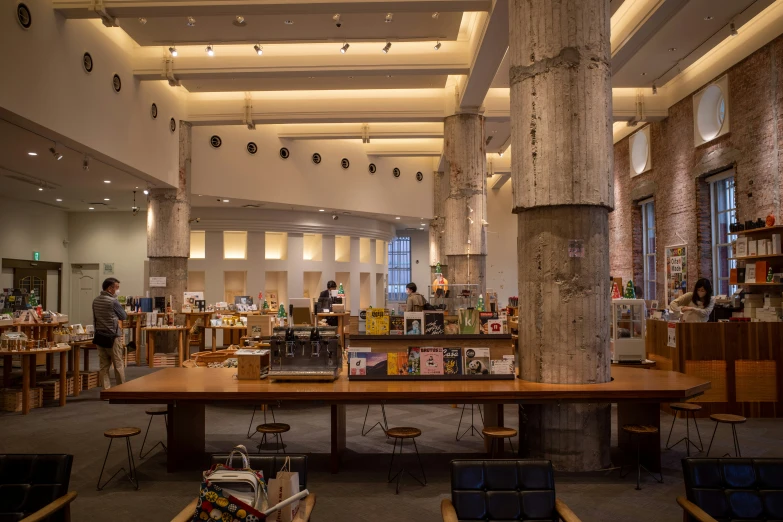 an interior s of a large reading room with books on the tables