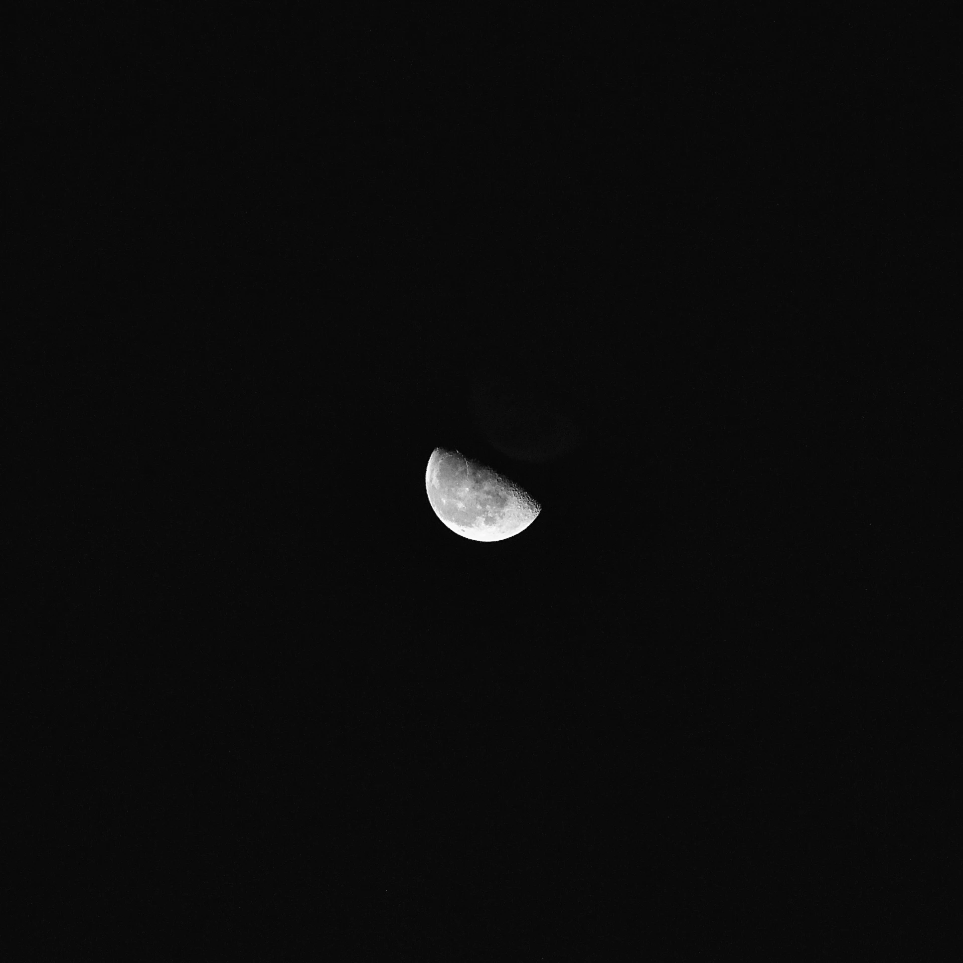 a moon in the middle of black night sky