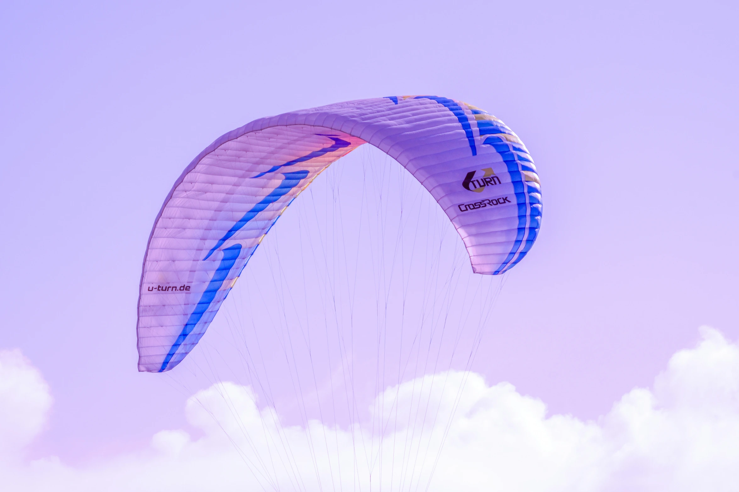 two kites are in the air with a cloudy sky