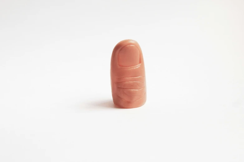 a small finger shaped toy on top of a white background