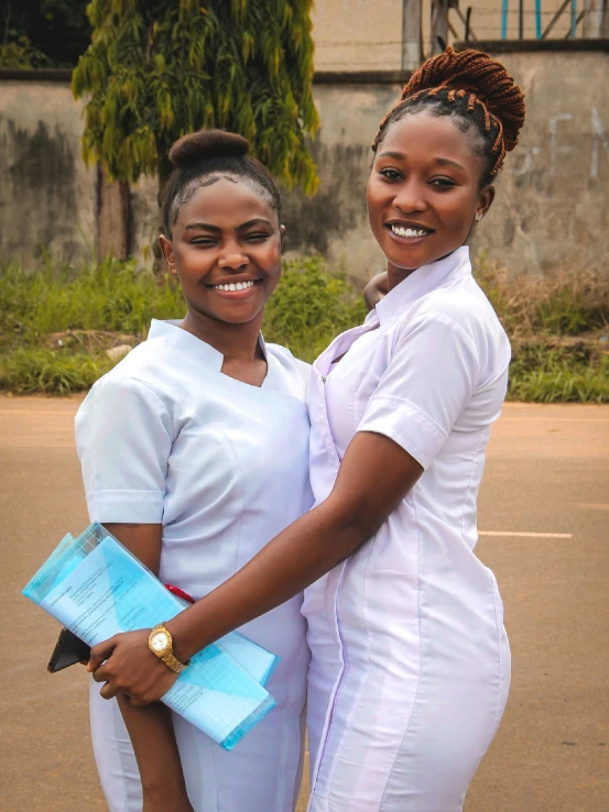 two women who are standing together in a parking lot