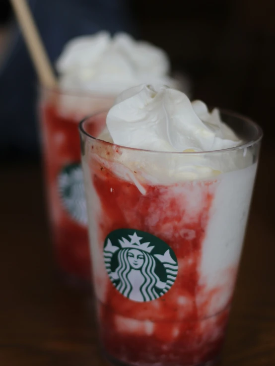 a pair of cups with whipped cream on top of them