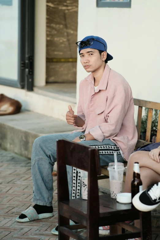 a young man is sitting on a bench