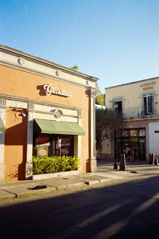 an empty street in front of a store with a parking meter and a store sign on it