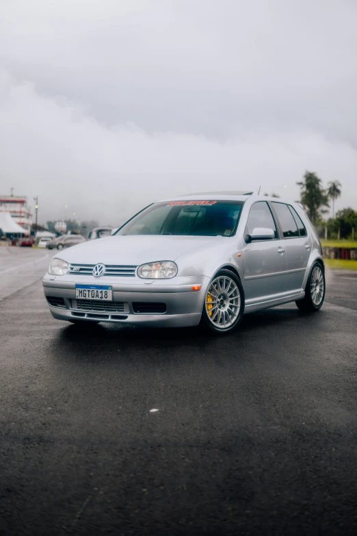 a silver car that is parked in a lot