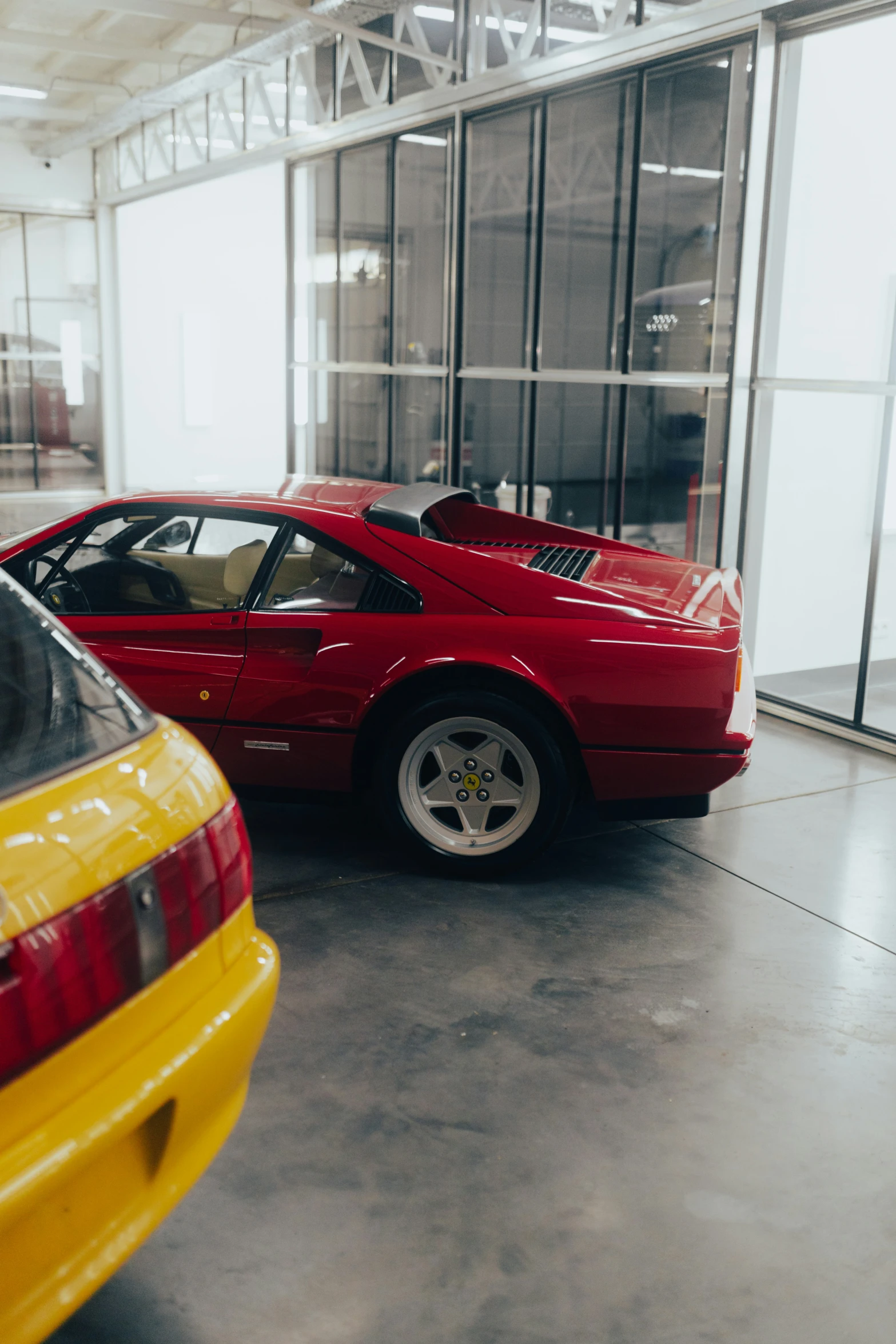 two very clean cars in an empty building