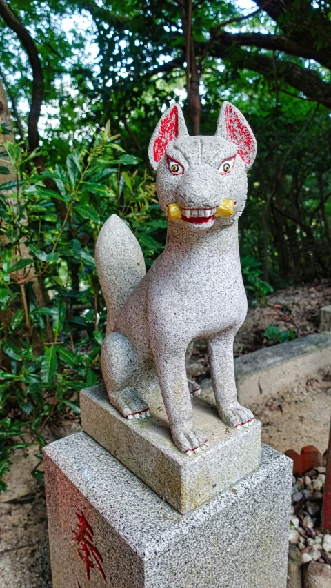 an animal statue on cement in front of trees
