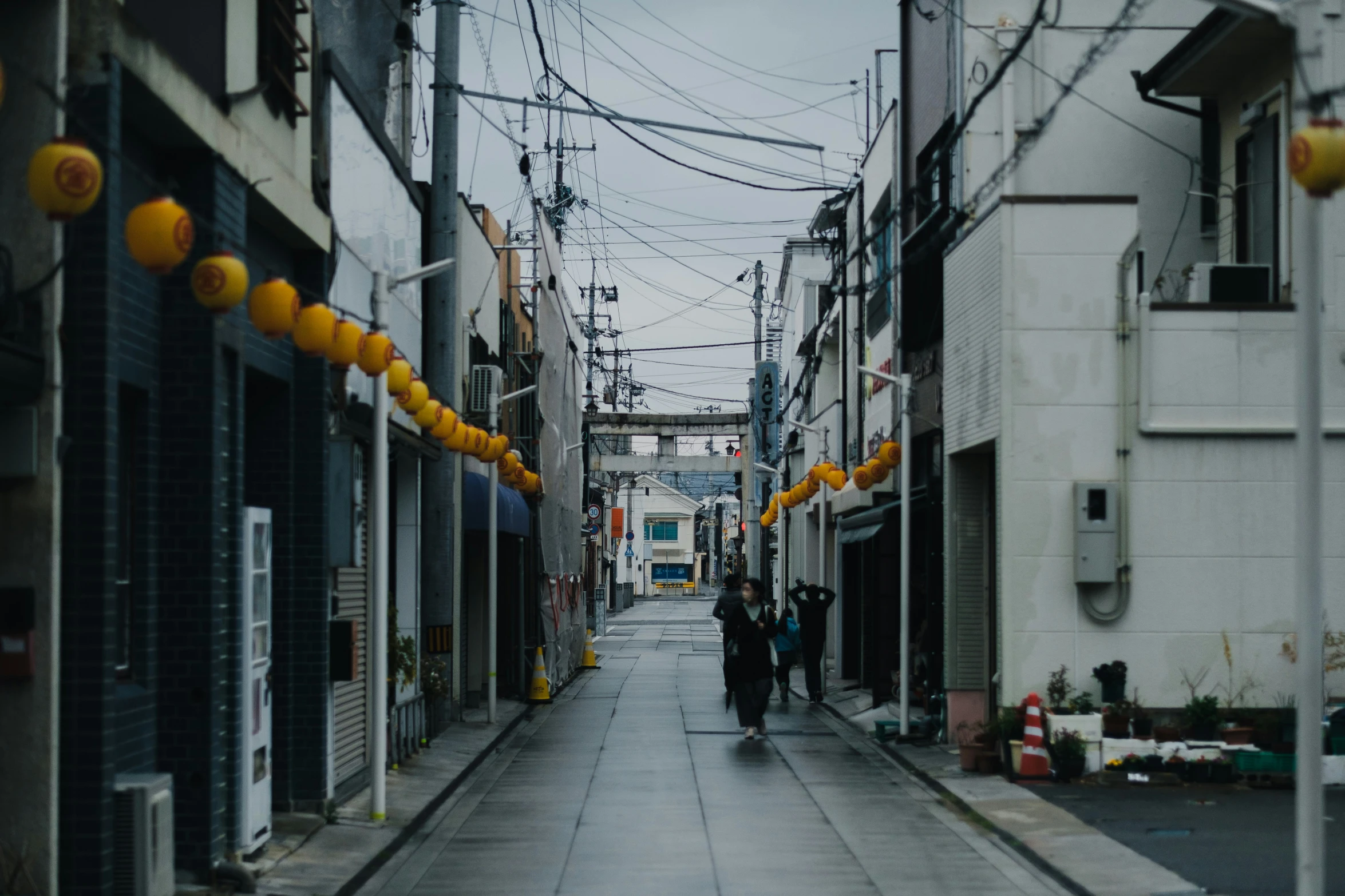 an empty street lined with tall buildings and buildings in the distance