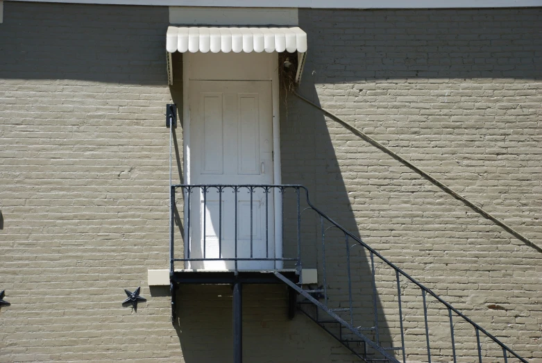 small white door on the side of a building