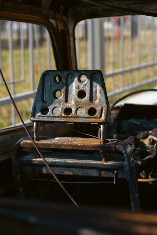 an old car with a rusted engine sitting in the back