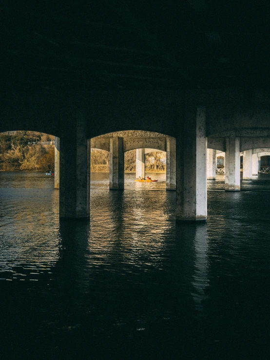 a bridge with lights on is shown in the night