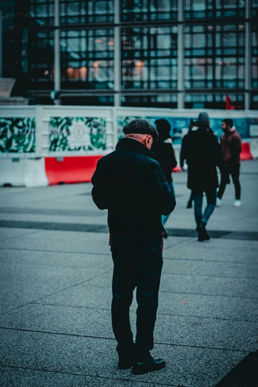 a man standing with another man on the street