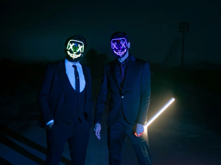 two people in masks standing next to each other