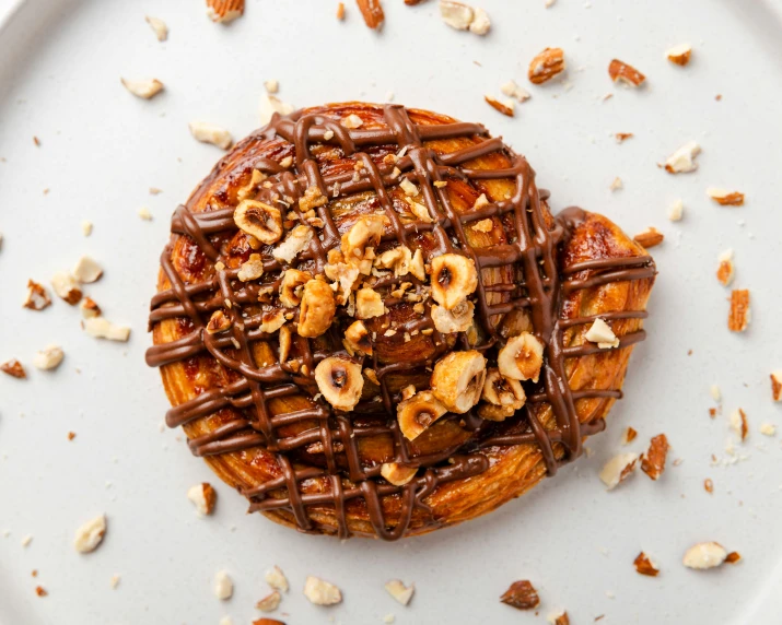 chocolate covered pastry and nuts on top of a white plate