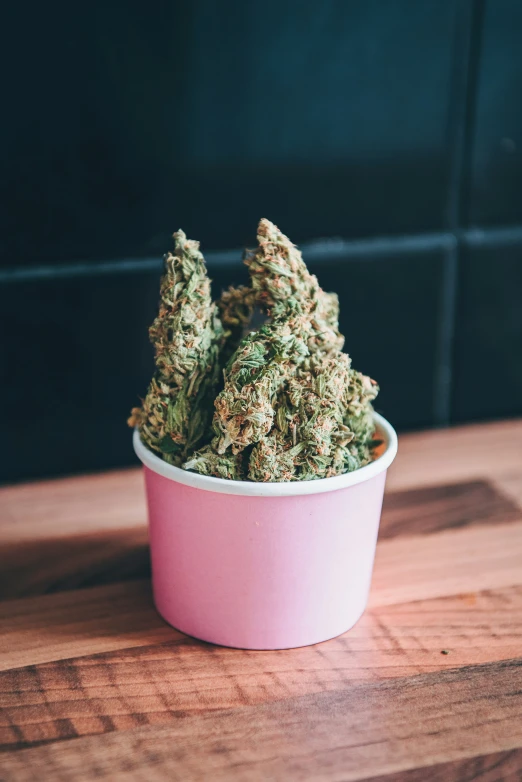 a pink bowl filled with lots of weed